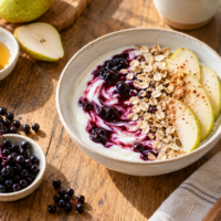 Elderberry yogurt breakfast bowl with pear and oats